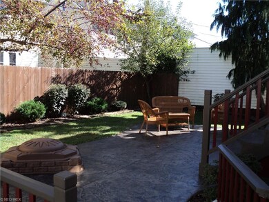 Low maintenance back yard with stamped concrete patio and privacy fence.