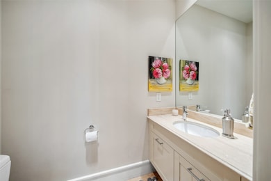 A stylish powder bath serves the first floor, comp