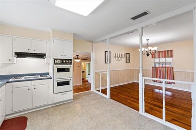 From kitchen, looking into dining area and den.