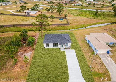 Birds eye view of property with a water view