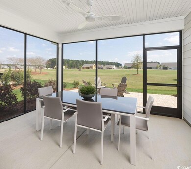 Sunroom / solarium with outdoor dining space, healthy amount of natural light, and ceiling fan