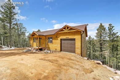 View of front of house featuring faux log siding, 