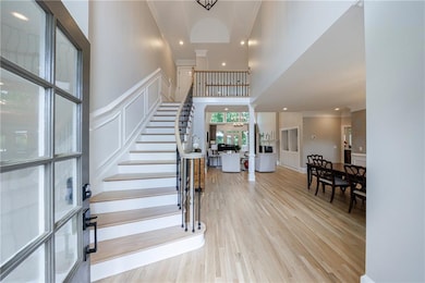 Entry opens to gleaming light white oak hardwood  floors throughout main and second level