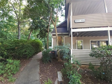 View of property exterior featuring a central air condition unit and roof with shingles