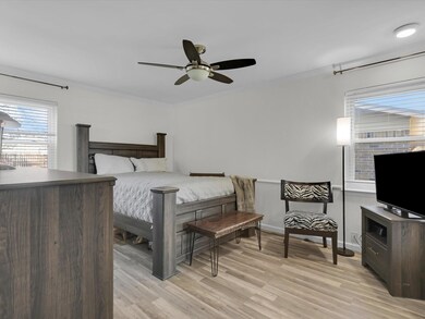 Bedroom featuring ornamental molding, light hardwo