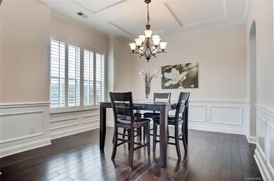 Formal Dining Room with Wood Flooring, Coffered Ce