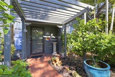 Doorway to property with a pergola