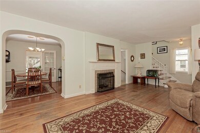 Another view of the living room and archway into t