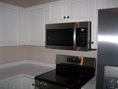 Kitchen with white cabinetry, stainless steel appl