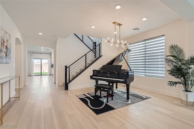 floors, recessed lighting, arched walkways, stairway, and a chandelier