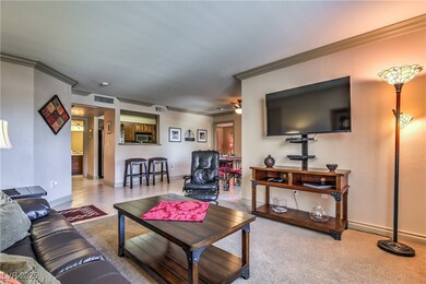 Carpeted living room featuring crown molding, base