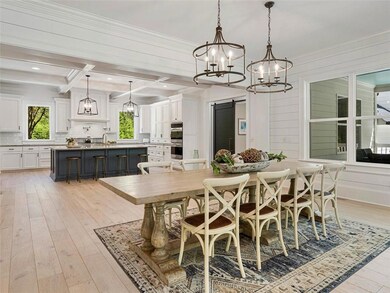 Dining room with ornamental molding, light wood fi