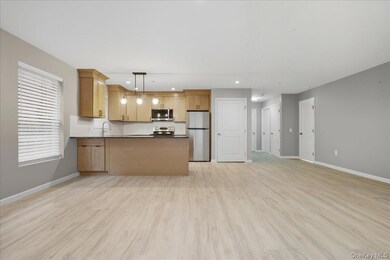 Kitchen Featuring Open Floor plan, Luxury Vinyl Plank Floors, Stainless Steel Appliances, Large Peninsula w/Hanging Pendant Light Fixtures, and Granite Countertops