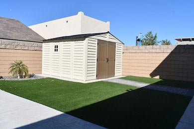View of storage shed with a fenced backyard