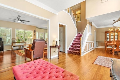 Entrance foyer with stairway, light wood-style flooring, open floor plan.