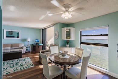 Dining room featuring ceiling fan, dark hardwood /