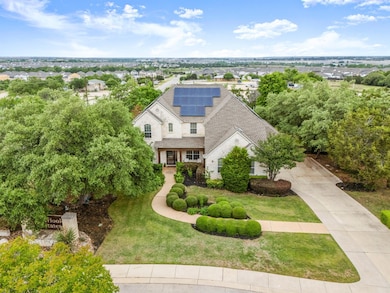 View of front of property with solar panels, a sh