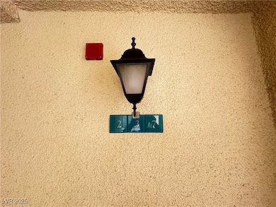 Exterior view of a fire alarm and stucco siding