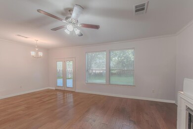 Empty room with crown molding, light wood-style f