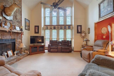 Large living room with handsome fireplace and tall