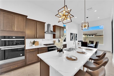 Kitchen with wall chimney range hood, a sink, mult