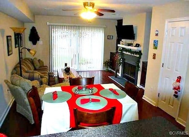 Dining space with a fireplace, wood finished floor