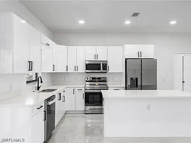 Kitchen with sink, appliances with stainless steel