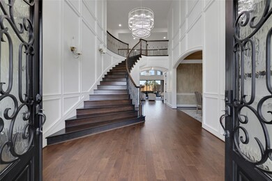 This stunning foyer with curved staircase is very welcoming. The office is to the left, the dining room is on the right, as is the 1/2 bath.