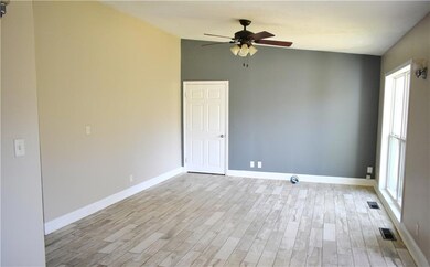 Empty room with light wood finished floors, visibl
