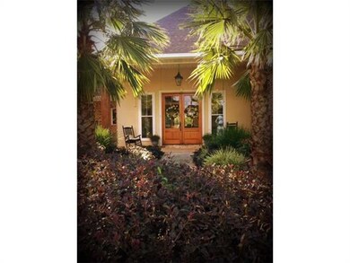 Photo. double door entry with lush landscape