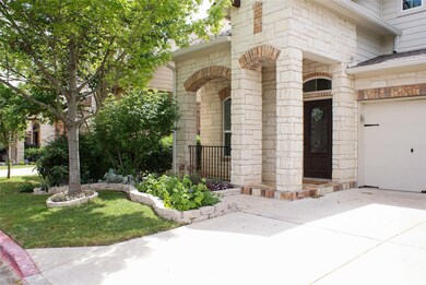 Doorway to property featuring driveway and stone 