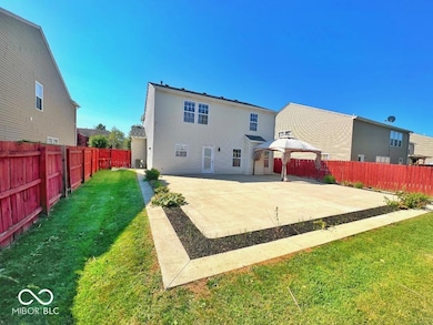 rear view of property featuring a pergula, a patio, and a fenced backyard