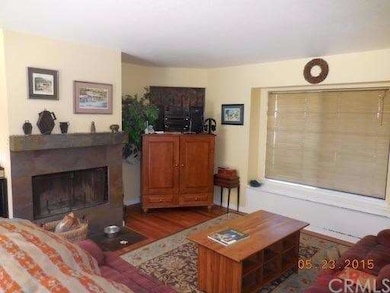 Den open to the kitchen with fireplace