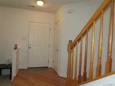 Foyer has wood floors and coat closet