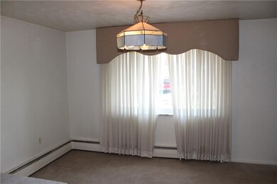 Dining room with large window and chandelier with 