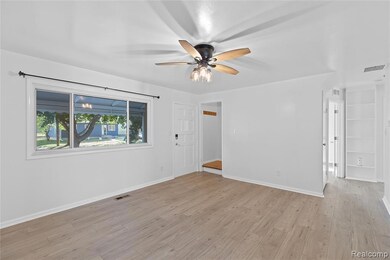 Spare room featuring light wood-style flooring and ceiling fan