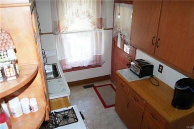 The kitchen has tall cabinets for plenty of storag