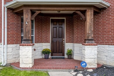 The covered front porch warmly welcomes you as you enter the pristine home.
