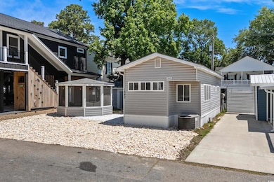 View of front of property with a sunroom and cooling unit