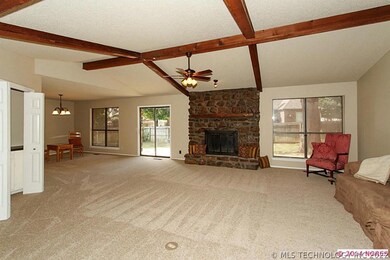Vaulted with wood beam, fireplace, & wet bar.