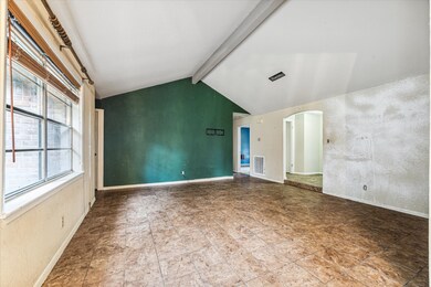 Den area connects to the kitchen