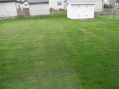 Exterior Front. Fenced in yard with shed and cover