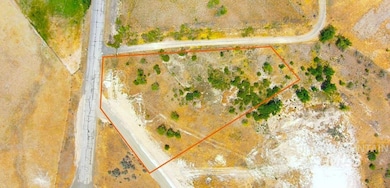 Aerial view of sparsely populated area with property parcel outlined