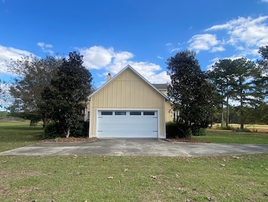 SIDE OF HOME SHOWING GARAGE