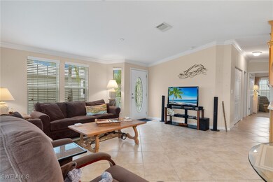 Tiled living room featuring ornamental molding and