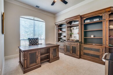 Tiled office space with crown molding and ceiling fan