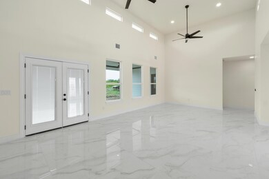 Unfurnished living room featuring baseboards, cei