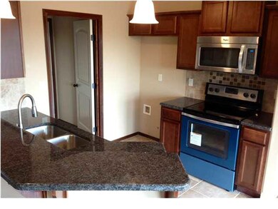 Kitchen has granite counters with granite eating b