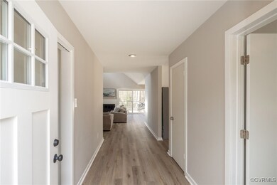 Hallway with light wood-type flooring and baseboar