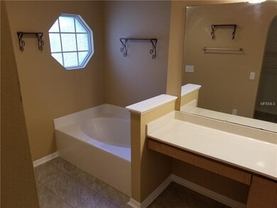Master bathroom with vanity, garden tub, and separ